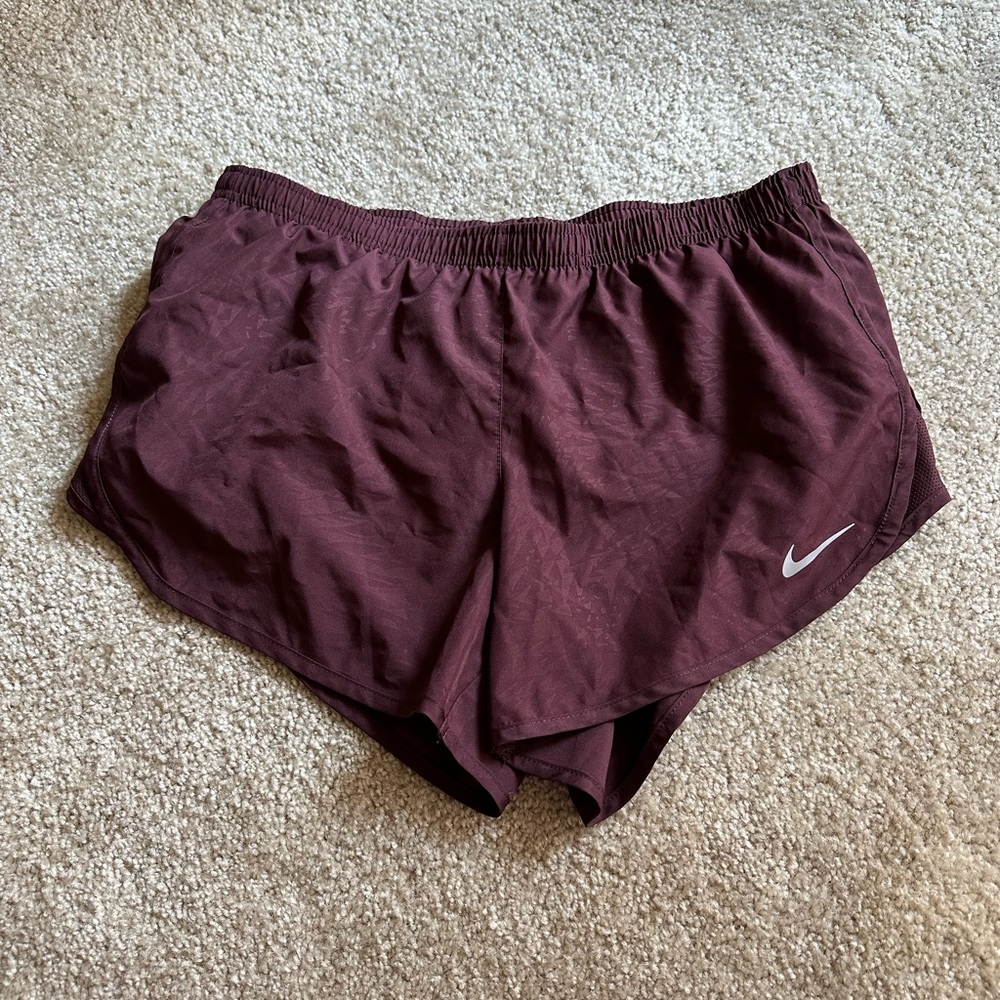 Burgundy Nike Women’s running shorts. Size medium. Back pocket.